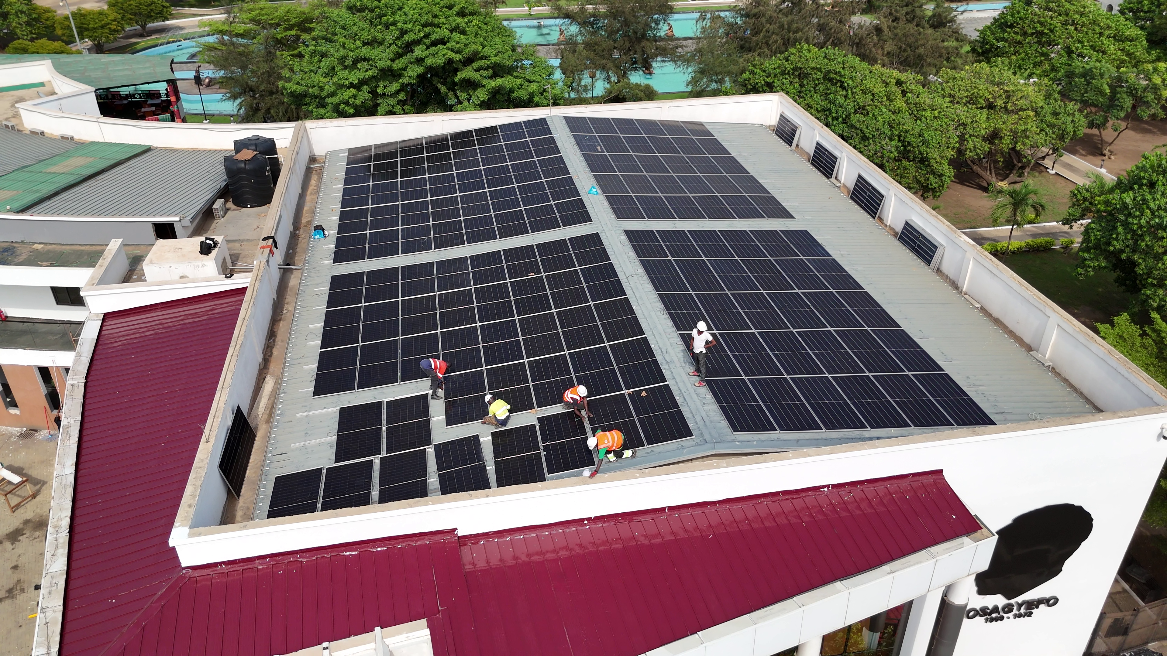 Engineers installing rooftop solar panels in Kumasi
